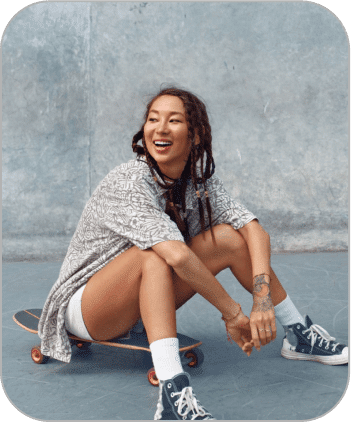 A girl sits on the skateboard