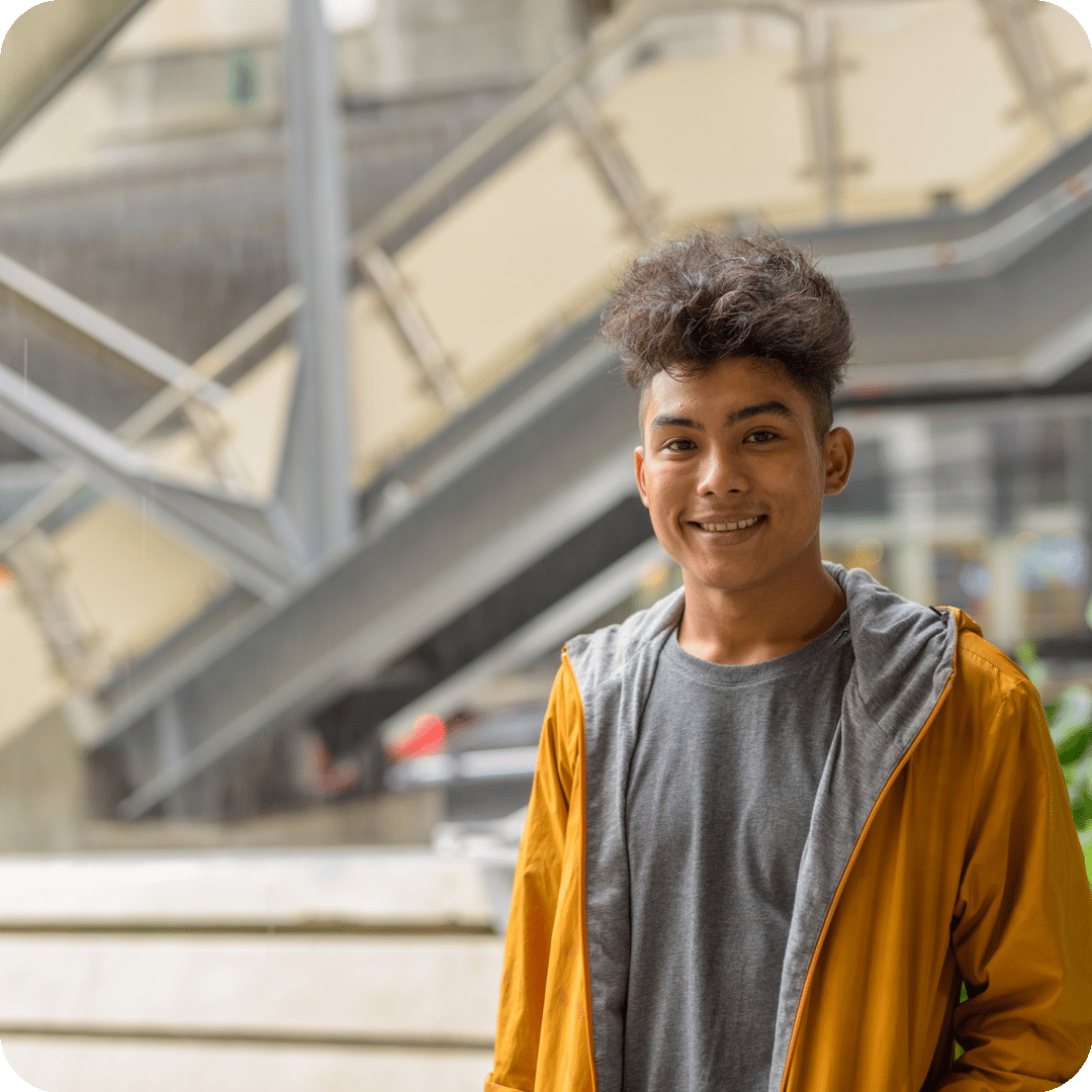 Happy young asian man with curly hair smiling