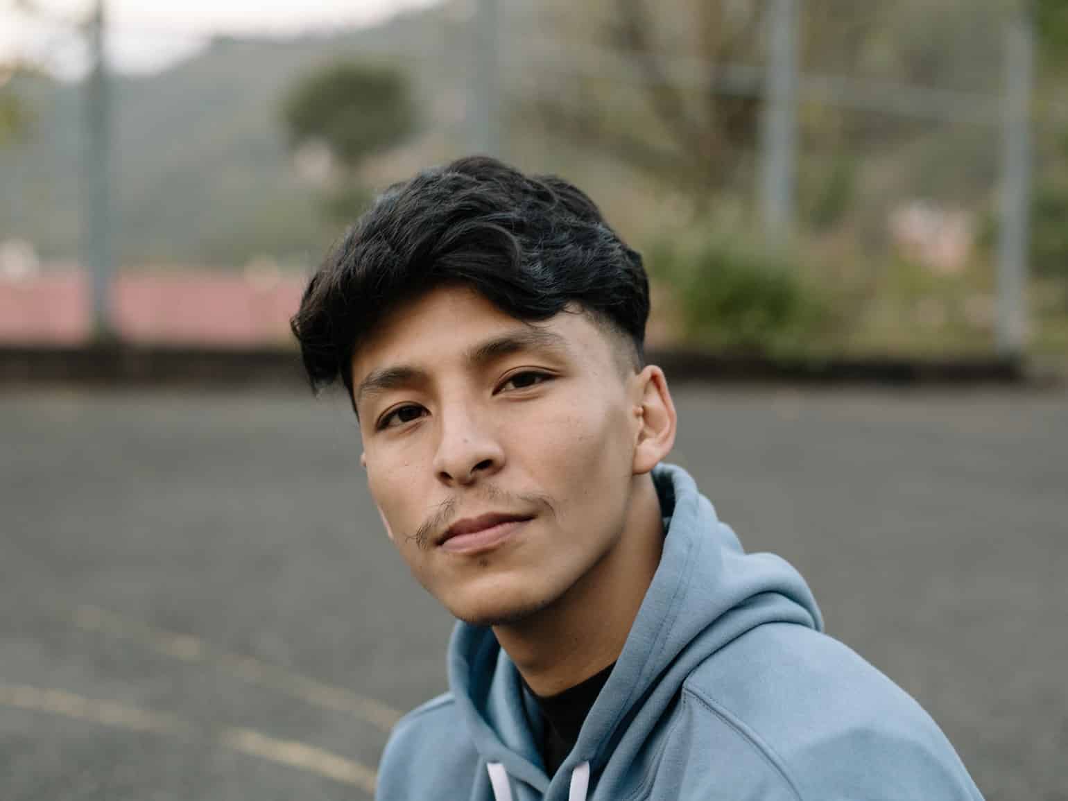 Portrait of a young south asian man looking at the camera