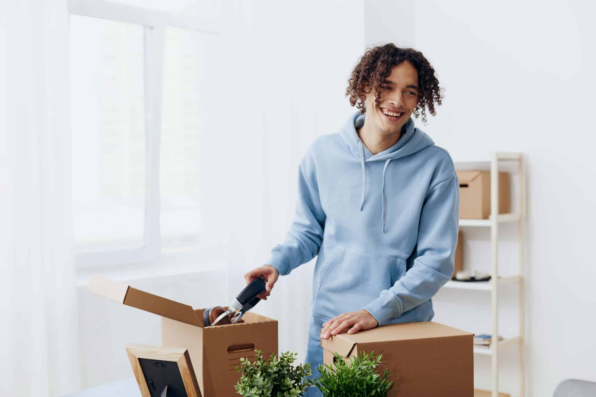 Young man packing boxes