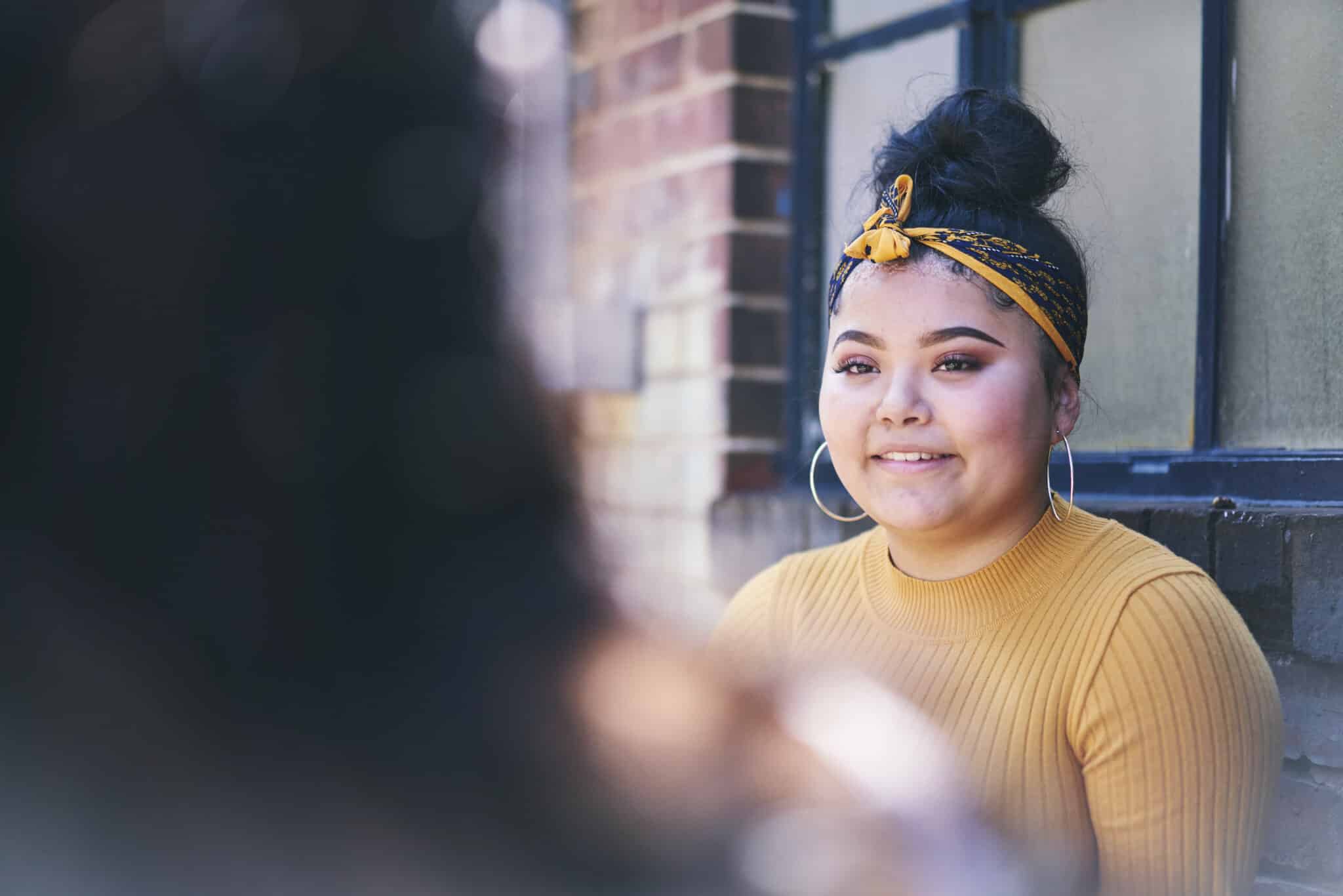 Teenage girl standing in doorway, over shoulder view